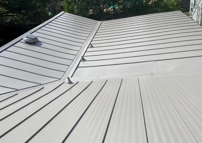Solar attic fan installed on a metal roof for Roof Ventilation in Pecan Grove